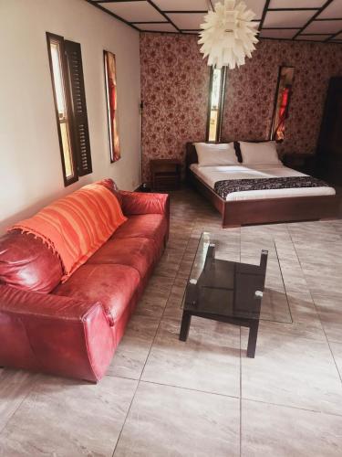 a living room with a couch and two beds at Manjuwele Lodge in Limbe