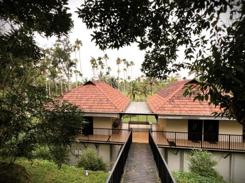 a building with a staircase leading up to it at Caffeine Villa in Kaniyāmbetta