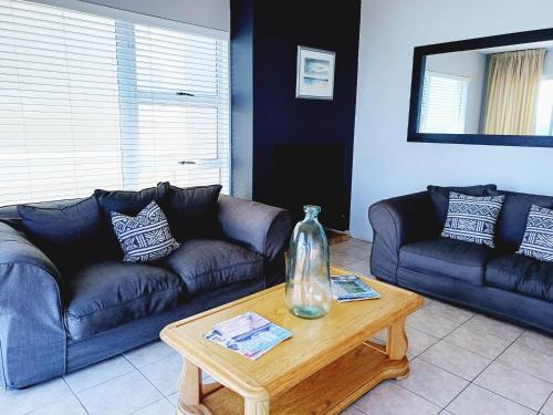 a living room with a couch and a coffee table at Langebaan Beach Towers in Langebaan