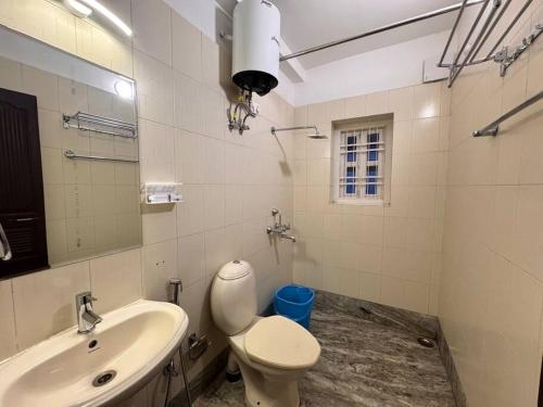 a bathroom with a toilet and a sink at Ariana Homestay in Siliguri