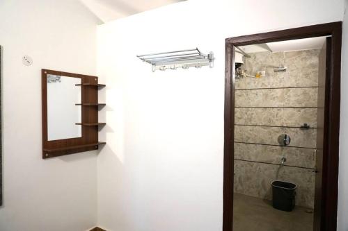 a bathroom with a shower and a mirror on the wall at Ariana Homestay in Siliguri