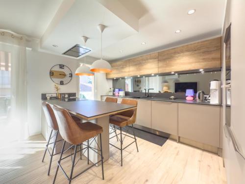 une cuisine avec une table et des tabourets de bar dans l'établissement Le Marcellin by Winsome Destination, à Cannes