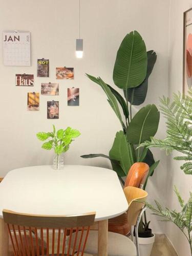 a dining room with a white table and plants at KojjeeBnB Bed Room2, Qeen size bed2, TV 2, #KSPO#JYP#Hanriver in Seoul