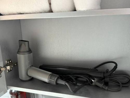 a hair dryer sitting on top of a shelf at KojjeeBnB Bed Room2, Qeen size bed2, TV 2, #KSPO#JYP#Hanriver in Seoul