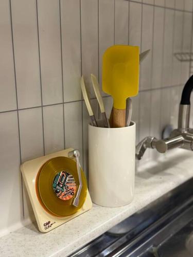 a kitchen counter with a cup with utensils on it at KojjeeBnB Bed Room2, Qeen size bed2, TV 2, #KSPO#JYP#Hanriver in Seoul