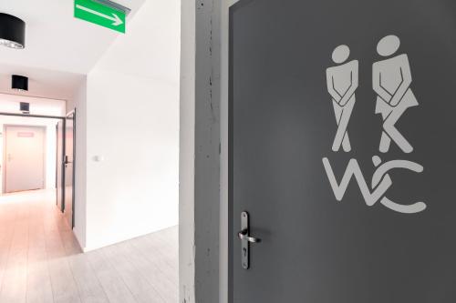 a door with a sign on it in a hallway at Cooltour Hostel in Poznań