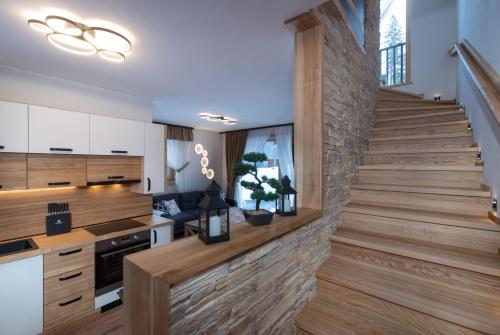 a staircase in a kitchen with wooden flooring at Chata Balux A in Liptovský Mikuláš