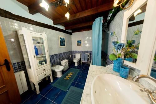 a bathroom with two toilets and a sink at Rural Enjoy Cantabria in Arnuero