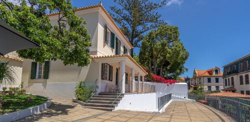 a white house with stairs and a fence at Villa Carvalhal in Funchal