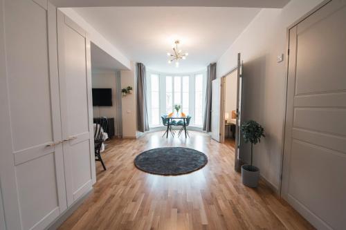 an empty living room with a table and a chair at Forenom Serviced Apartments Helsinki Töölö in Helsinki