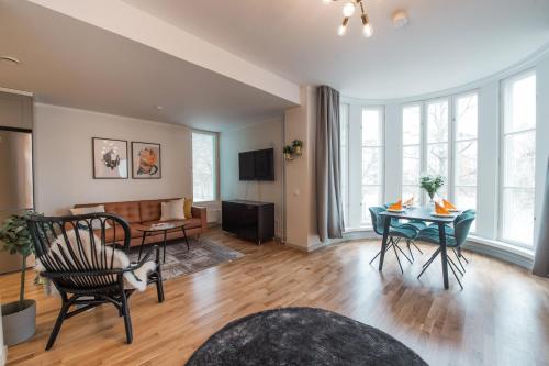 a living room with a couch and a table at Forenom Serviced Apartments Helsinki Töölö in Helsinki