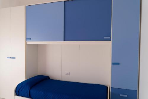 a bedroom with a blue bed and a cabinet at La Tartaruga in Siena