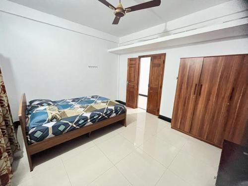 a bedroom with a bed and a ceiling fan at Chandra Guest House in Chankanai