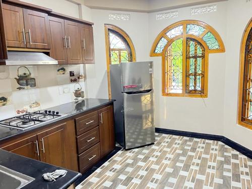 a kitchen with a stainless steel refrigerator at Chandra Guest House in Chankanai