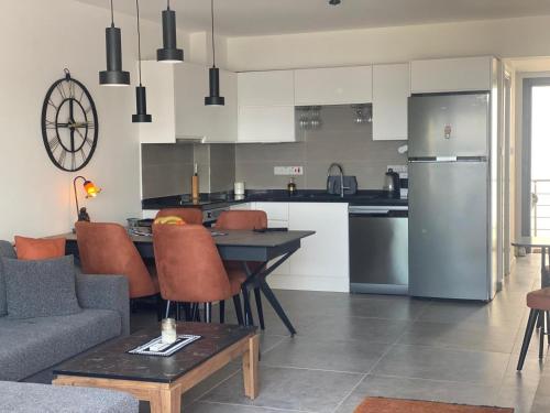 a kitchen and living room with a table and chairs at Deja Blue2 A2-5 penthouse with sea view in Bahçeli