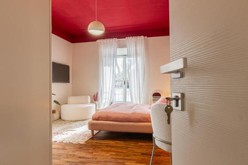 a bedroom with a bed with a red ceiling at DomusFebo SanGiovanniSuites in Rome