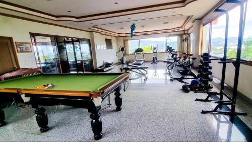 a fitness room with a pool table and tread machines at Bangrak Cozy Stay in Koh Samui 