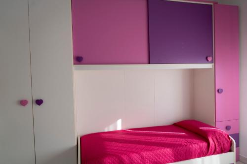 a bedroom with a bed with a purple canopy at La Tartaruga in Siena