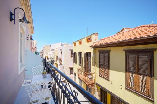 a balcony of a building with a table and chairs at Casa Kallergi in Chania Town