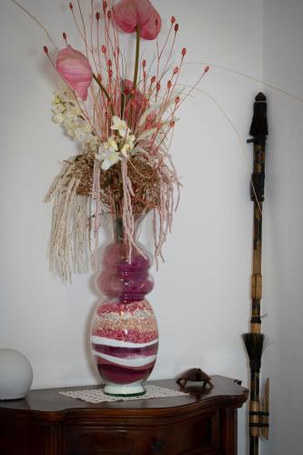 a vase with flowers in it on a table at La Tartaruga in Siena