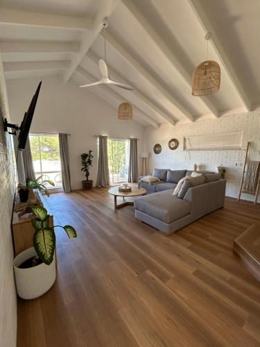 a living room with a couch and a table at Blue Holes Bungalow in Kalbarri