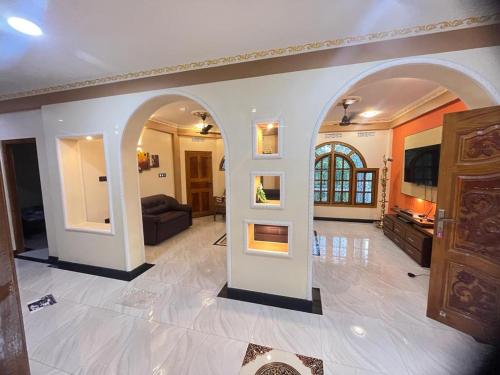 a living room with an archway in a house at Chandra Guest House in Chankanai