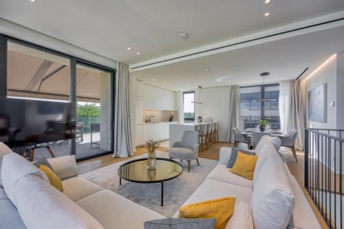 a living room with a white couch and a table at Villa 19 in Savudrija