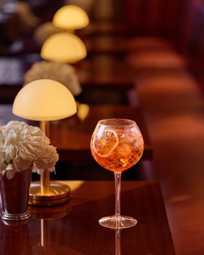 a glass of wine sitting on a table at The Selwyn, Richmond in Richmond upon Thames
