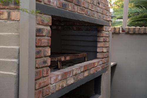 a brick wall with a bench inside of it at Gold Guest & Conference in Welkom