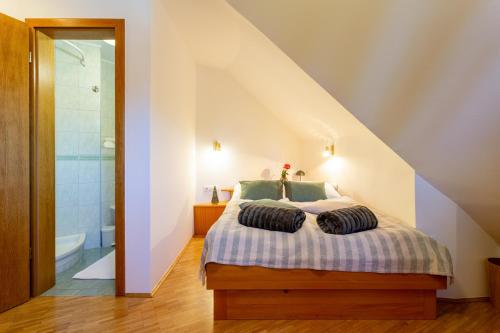 a bedroom with a bed with two pillows on it at Pohorski Dom in Pohorje