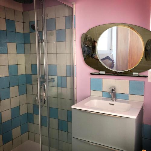 une salle de bain avec un lavabo et un miroir dans l'établissement Studio Brocante, à La Réole