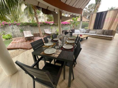 a black table and chairs on a patio at Agence Adjana Resort - Résidence du Port 3 in Sali Tapé