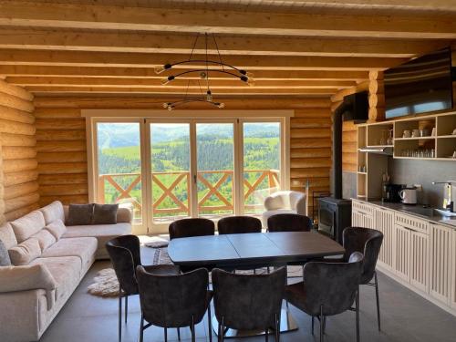 a living room with a table and a large window at Monte Vista 2 in Rostoka