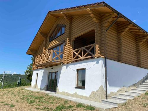 a house with a balcony on top of it at Monte Vista 2 in Rostoka