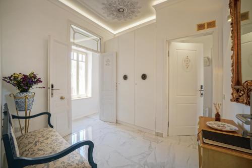 a dining room with a chair and a table at Casa Kallergi in Chania Town