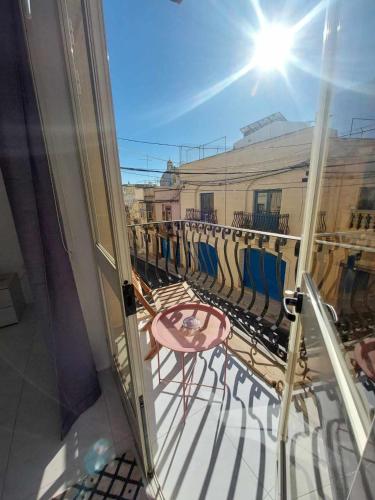 a view of a balcony with a table and chairs at Nr41 Holiday Apartment - Close to Village Centre, Promenade, Shops & Restaurants in Marsaxlokk