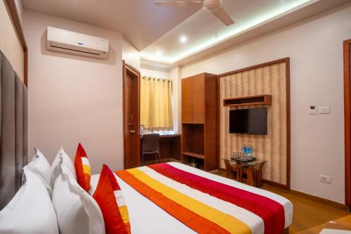 a hotel room with a bed and a television at Uddhav Vilas A Family Hotel in Udaipur