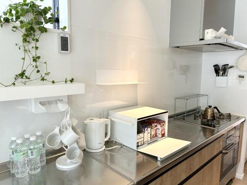 a kitchen with a counter with a coffee maker on it at Accessible Four-Bedroom House near Kuzuha Station! in Hirakata