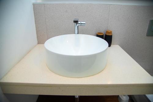 a white sink on a counter in a bathroom at The Pavilion 1BDR Luxury Apt in Accra