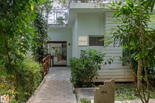 an entrance to a building with trees in front of it at Sterling Wayanad in Sultan Bathery