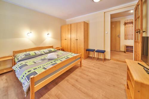 a bedroom with a bed and two chairs in it at Koula Apartments in Pec pod Sněžkou