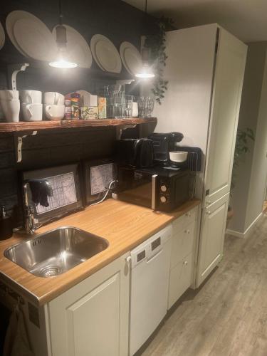 a kitchen with a sink and a counter at Stockholms home away from home in Stockholm