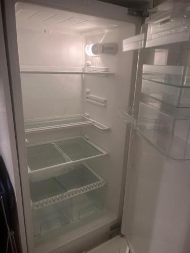 a white refrigerator with its door open with its at Stockholms home away from home in Stockholm