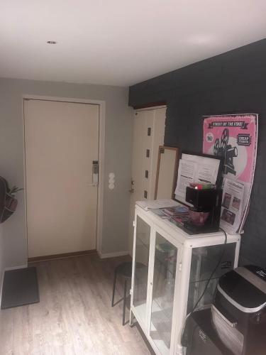 a room with a door and a table with a counter at Stockholms home away from home in Stockholm