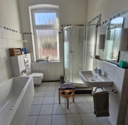 a bathroom with a tub and a sink and a shower at Ferienwohnung Mit Herz in Diez