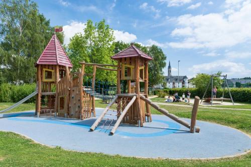 a playground with two wooden play equipment in a park at Ferienwohnung Mit Herz in Diez