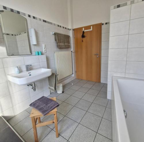 a bathroom with a sink and a toilet and a mirror at Ferienwohnung Mit Herz in Diez