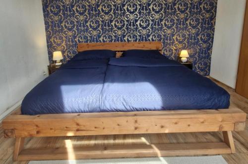 a bed with a blue comforter in a bedroom at Ferienwohnung Mit Herz in Diez