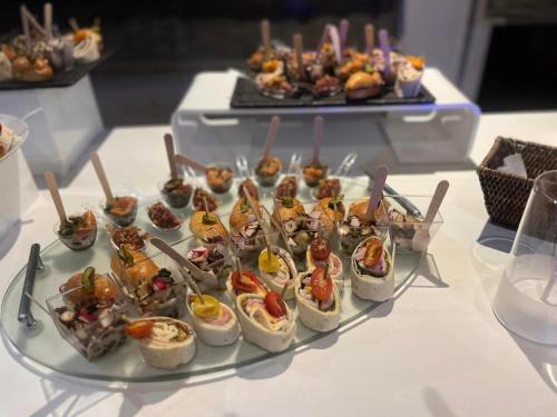 a tray of food on a table with appetizers at Ambiance Hotel in Limas