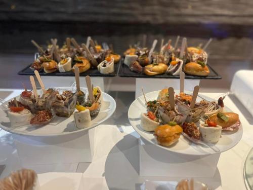 two plates of food on a table with appetizers at Ambiance Hotel in Limas
